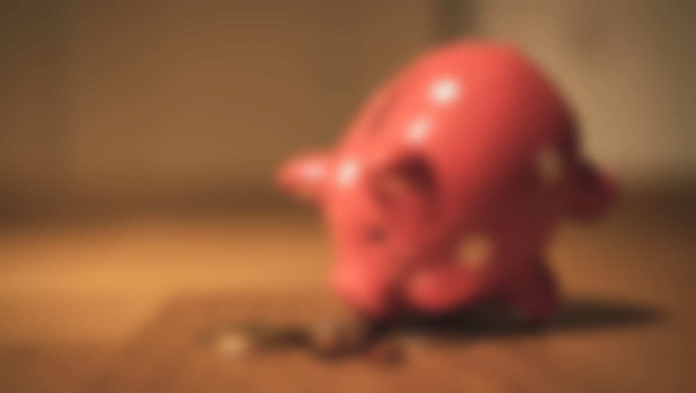 A thumbnail showcasing a piggy bank leaning forward with some coins around it's feet.