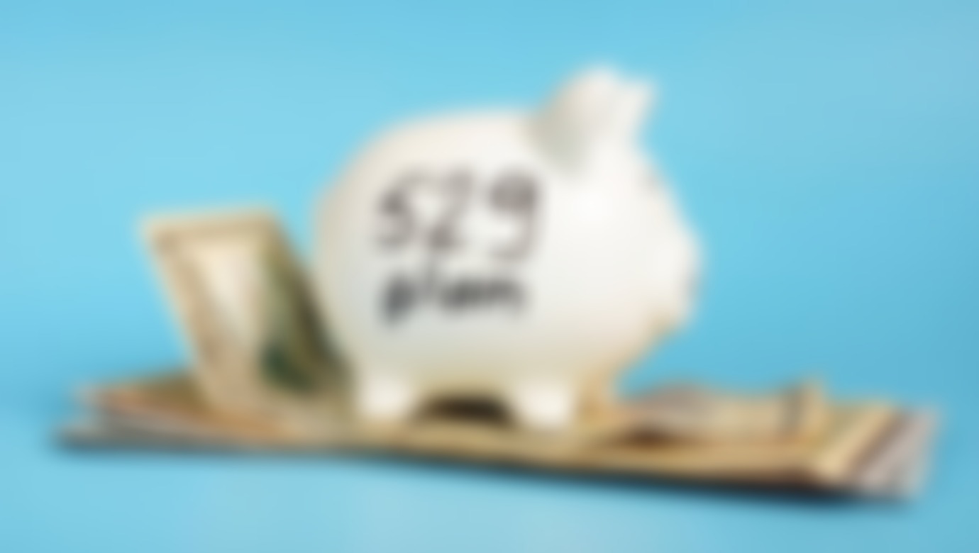 A thumbnail showcasing a piggy bank placed on top of money with the words 529 plan written on the side.